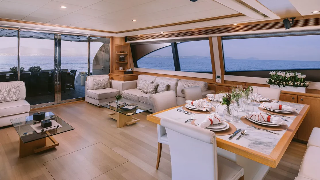 a large living room with a large window aboard MELI Yacht for Charter