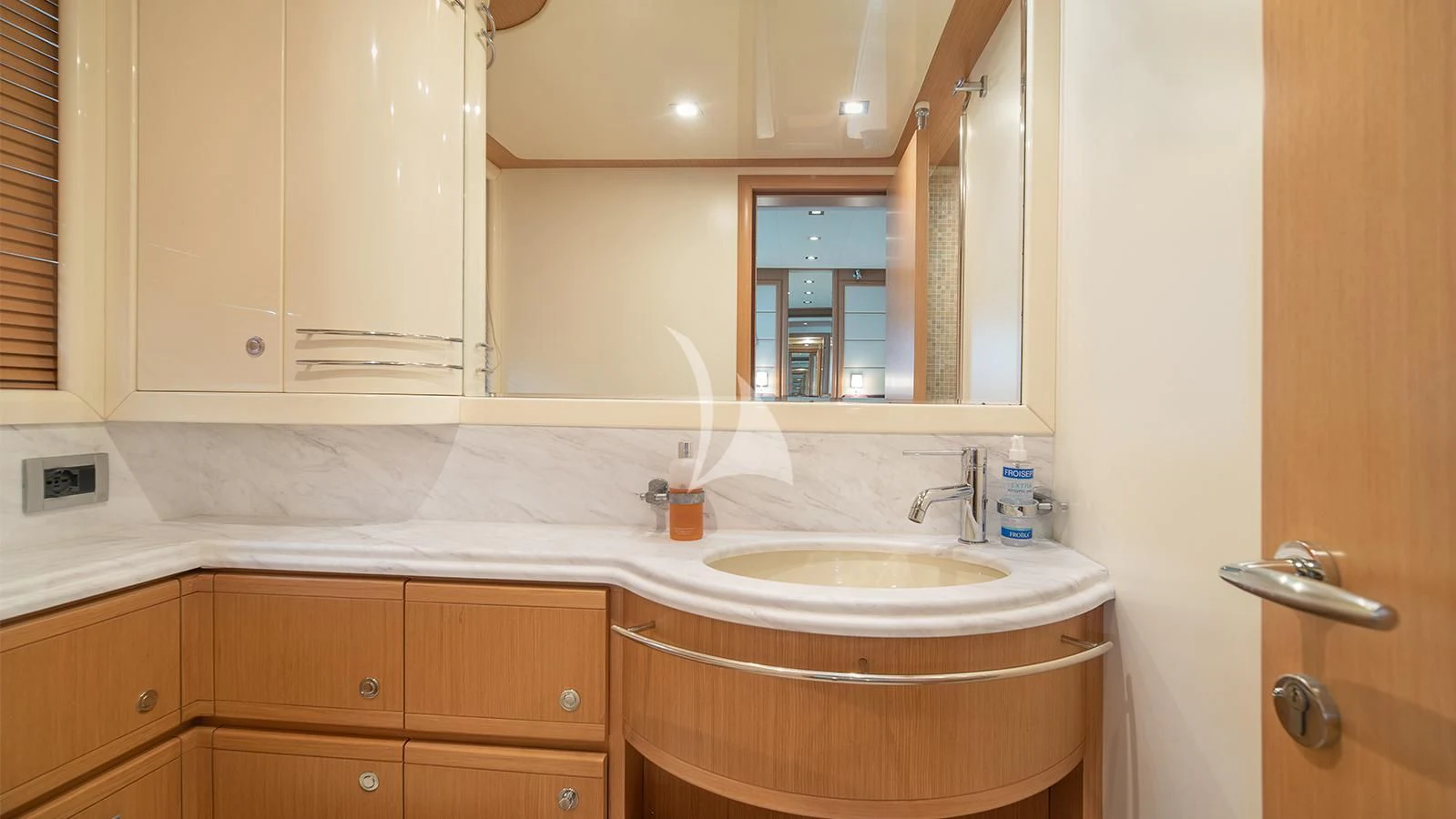 a bathroom with a sink and cabinets aboard MELI Yacht for Charter