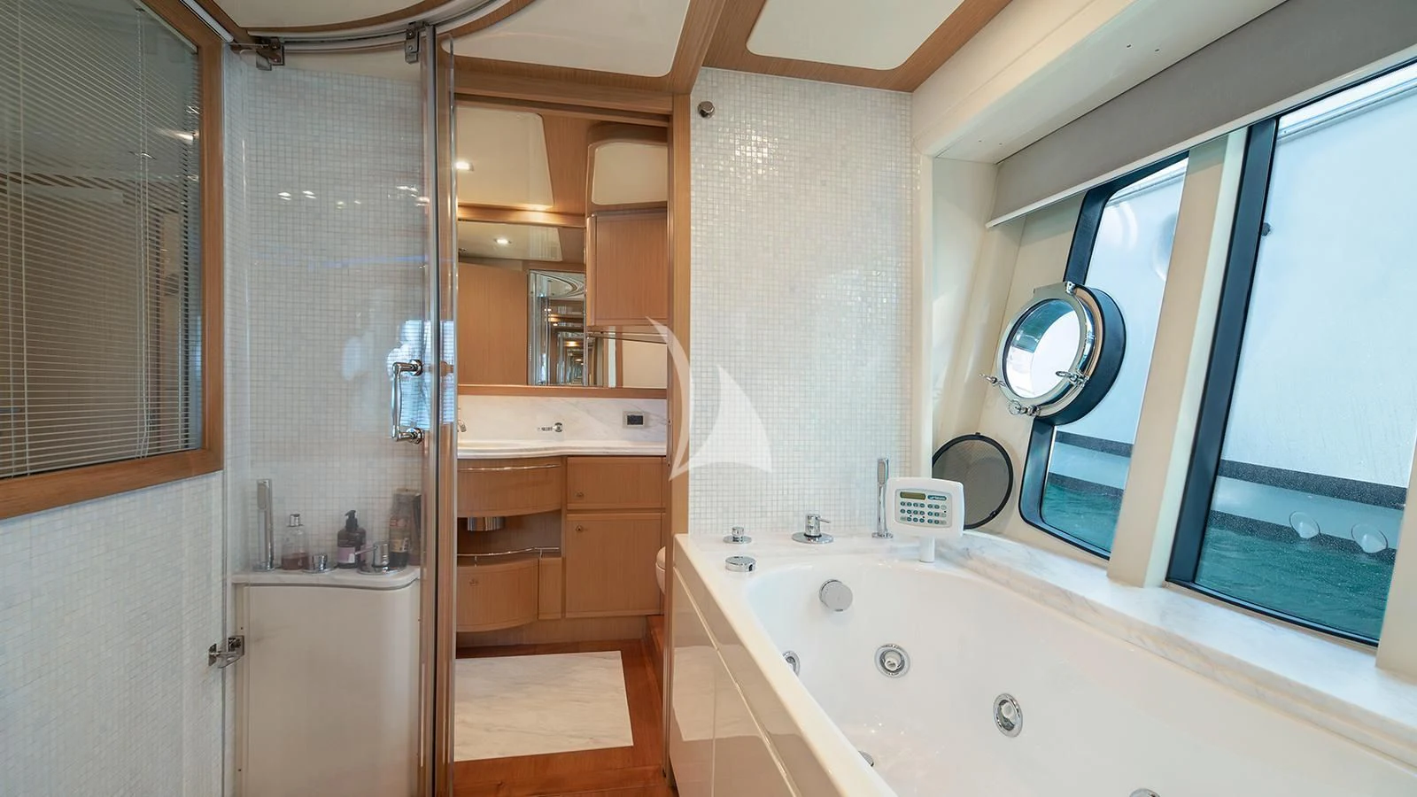 a bathroom with a tub sink and cabinets aboard MELI Yacht for Charter