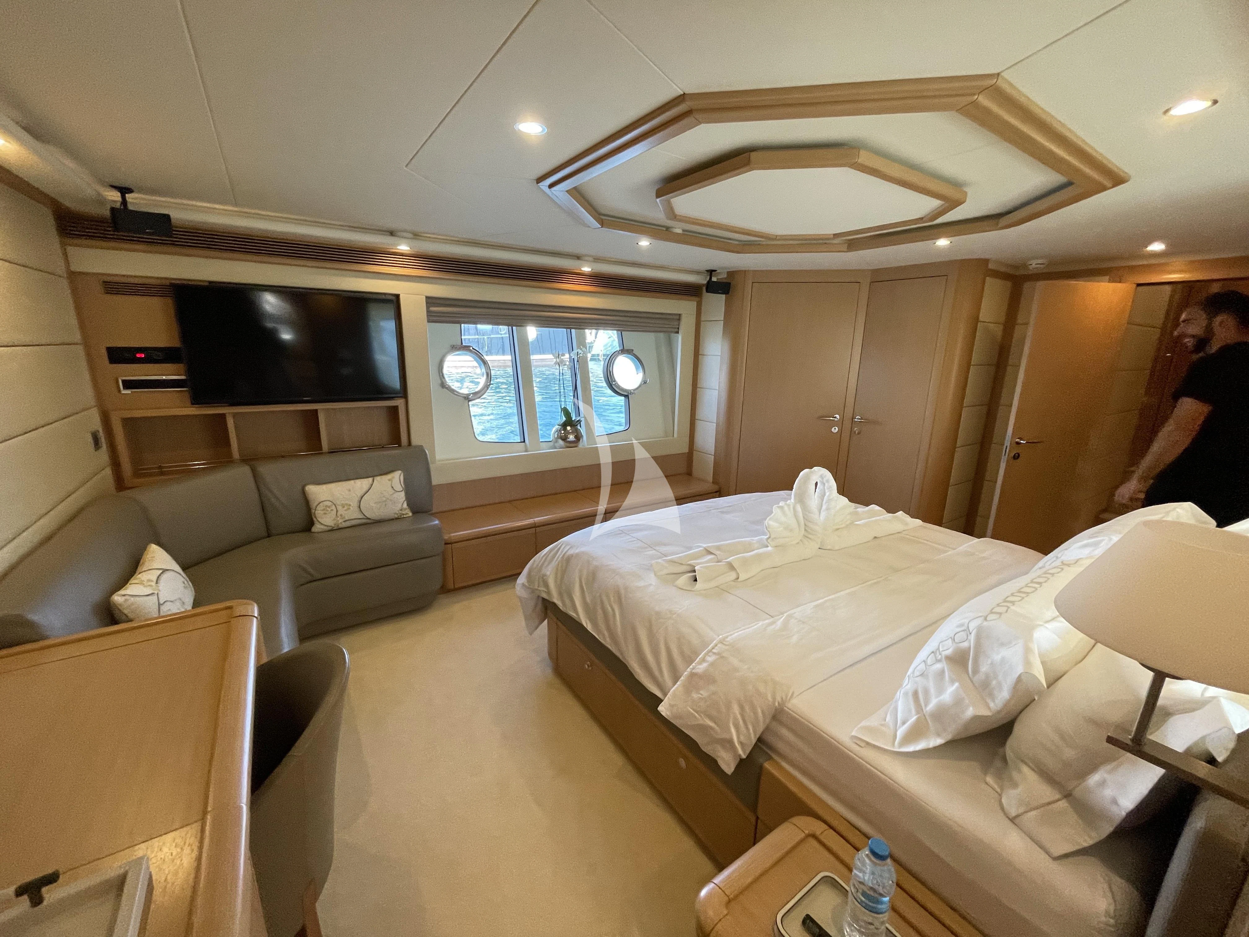 a room with a bed and a couch aboard MELI Yacht for Charter
