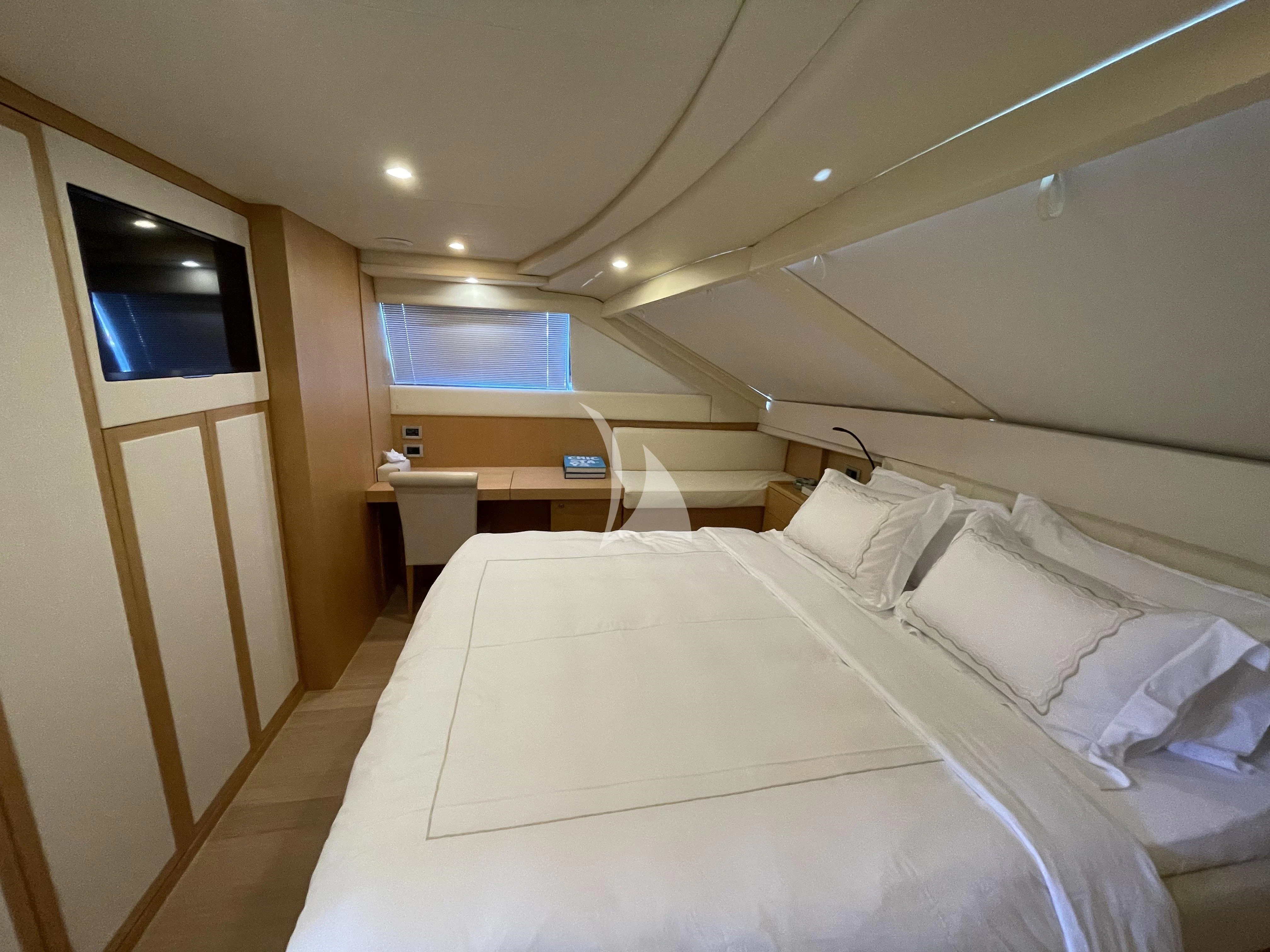 a room with a bed and a desk aboard MELI Yacht for Charter
