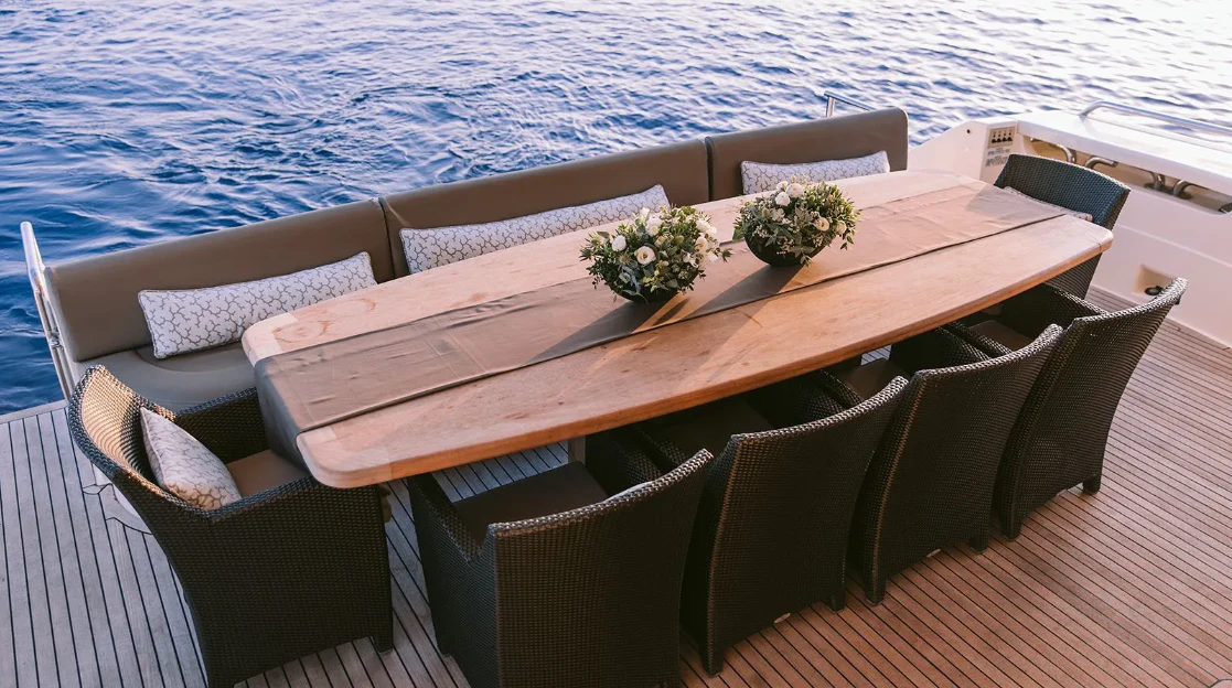 a table and chairs on a boat aboard MELI Yacht for Charter
