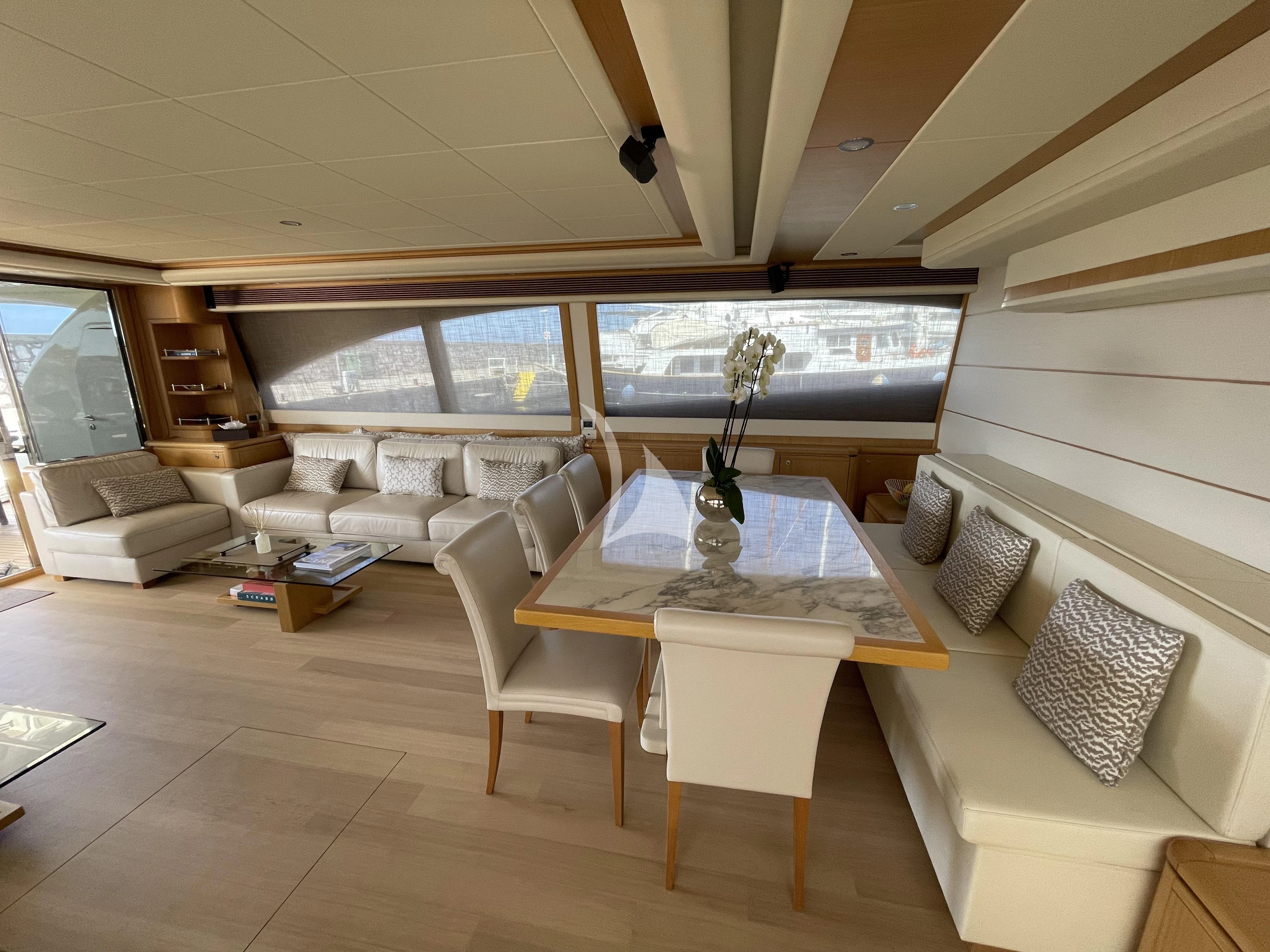 a room with a table and chairs aboard MELI Yacht for Charter