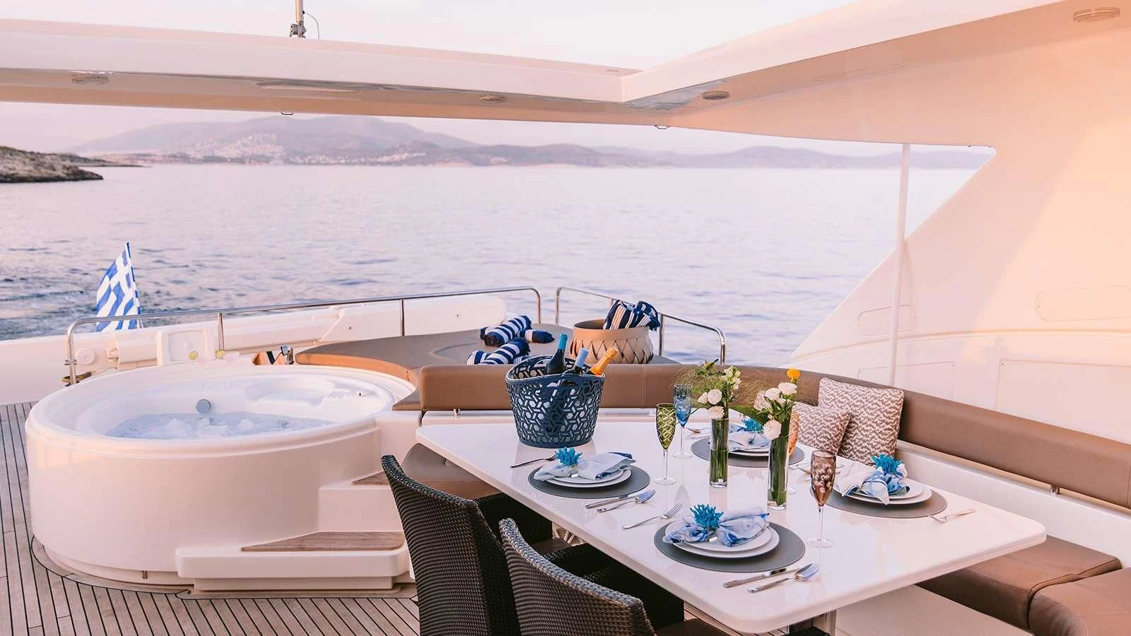 a table with plates and cups on it aboard MELI Yacht for Charter