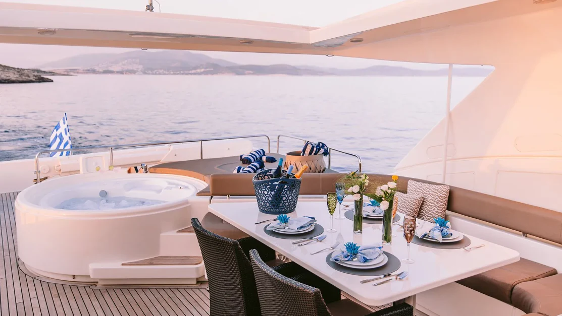 a table with plates and cups on it aboard MELI Yacht for Charter