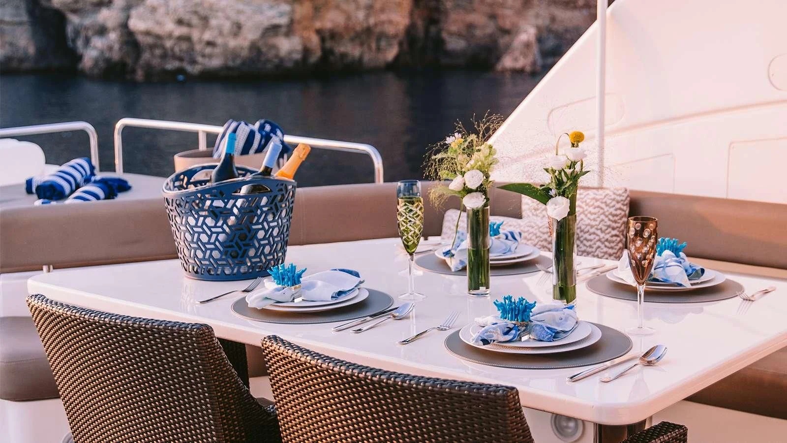 a table with plates and glasses on it aboard MELI Yacht for Charter