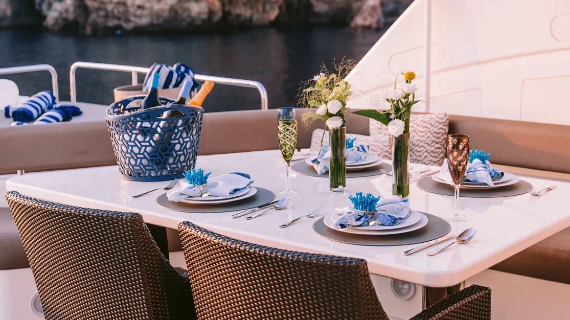 a table set with place settings aboard MELI Yacht for Charter