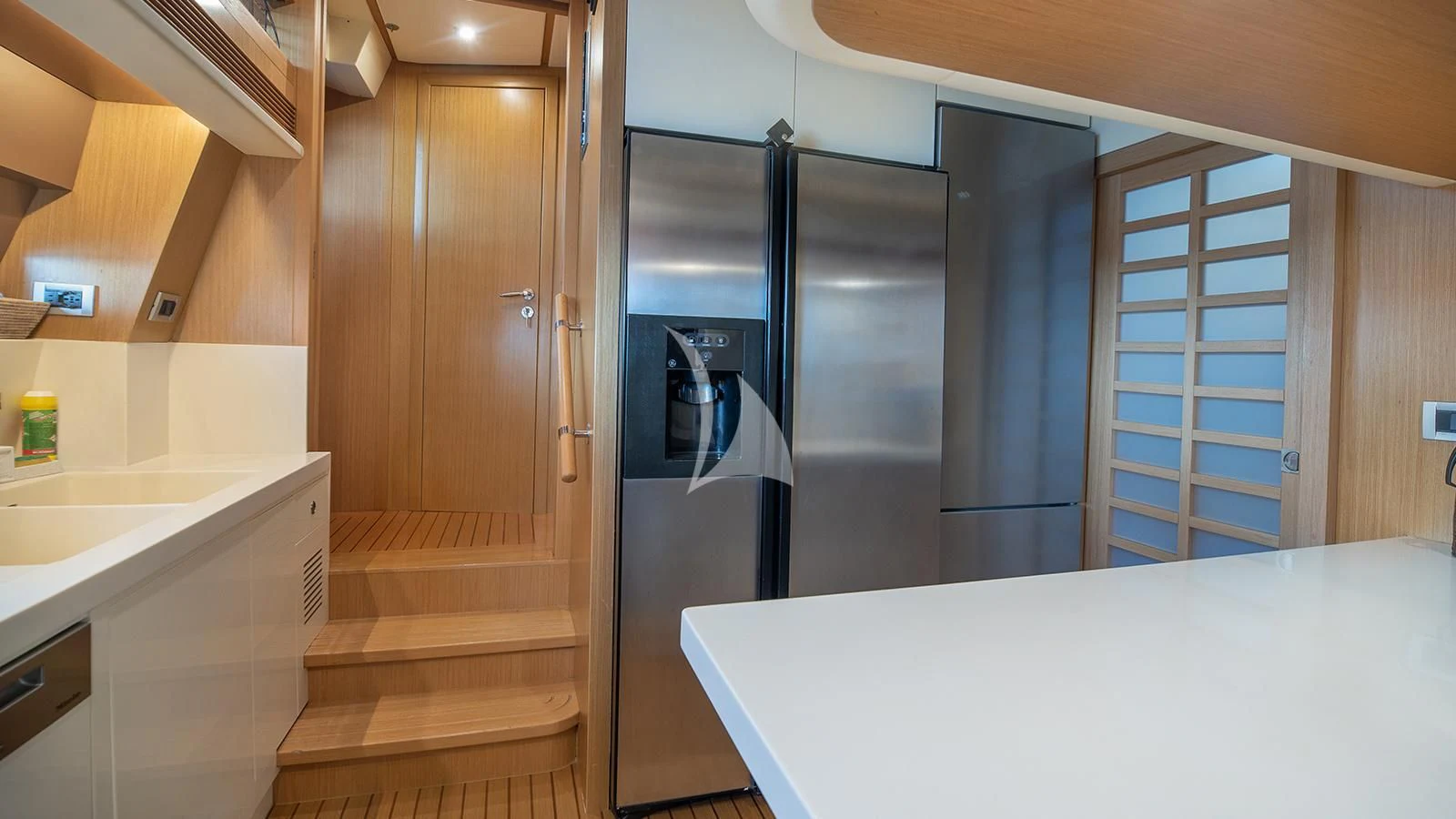 a kitchen with a refrigerator and a sink aboard MELI Yacht for Charter