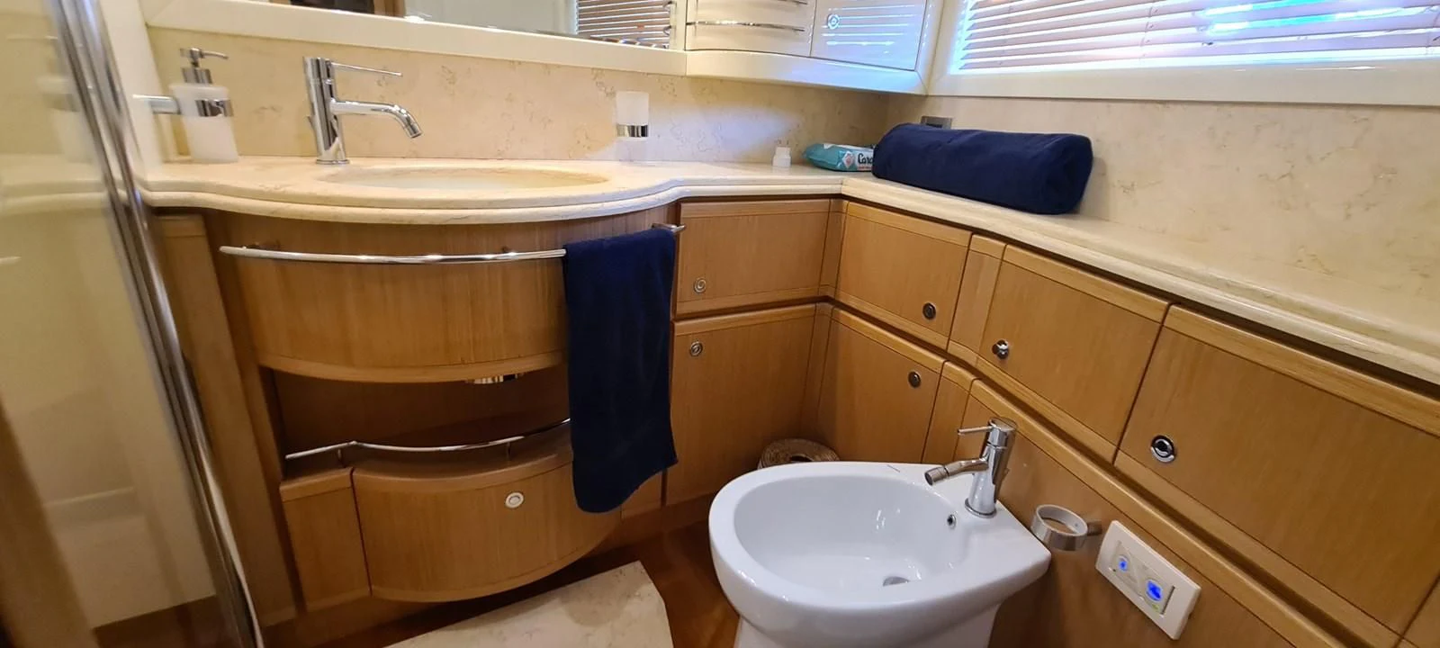 a bathroom with a sink and cabinets aboard MELI Yacht for Charter