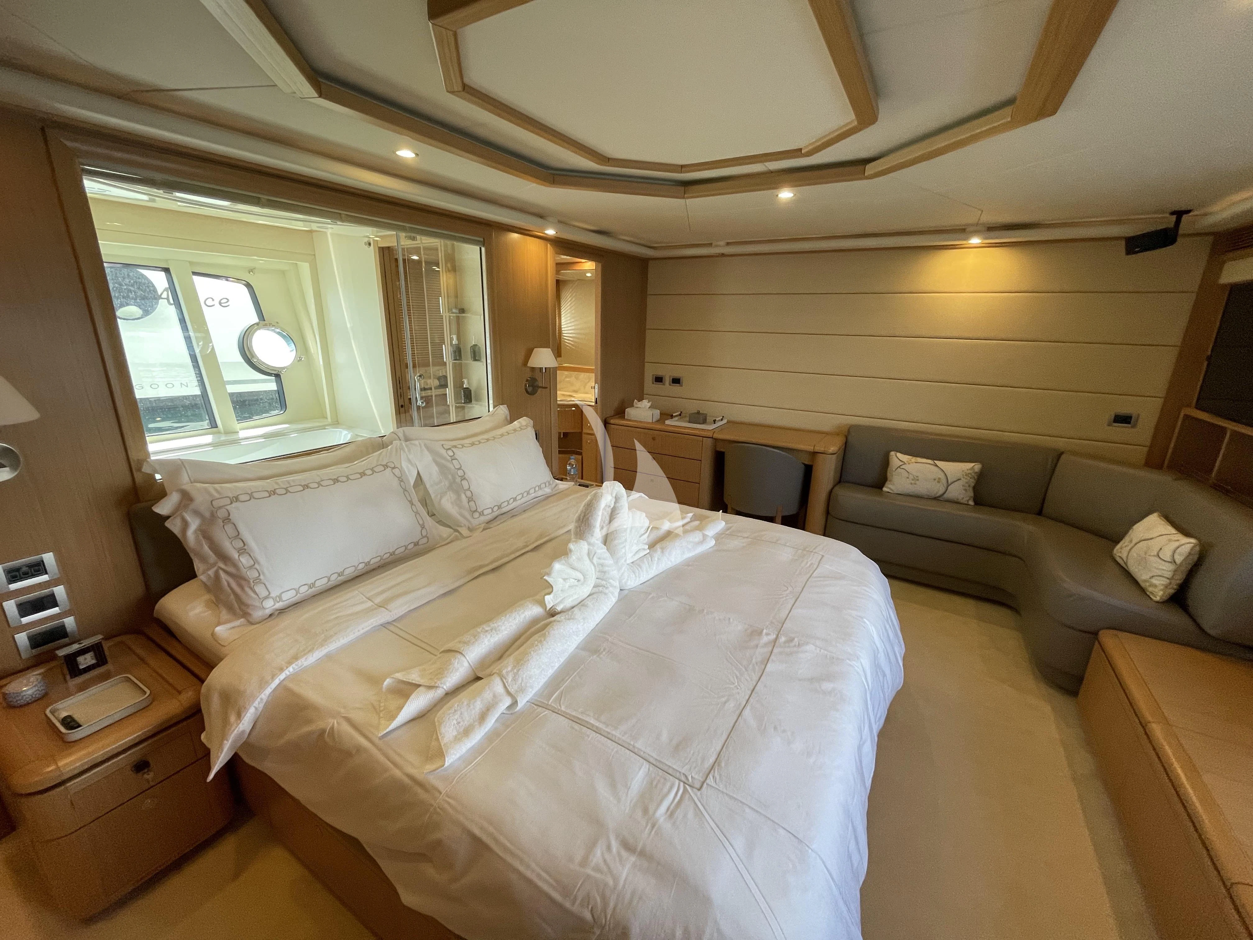 a bedroom with a bed and a couch aboard MELI Yacht for Charter