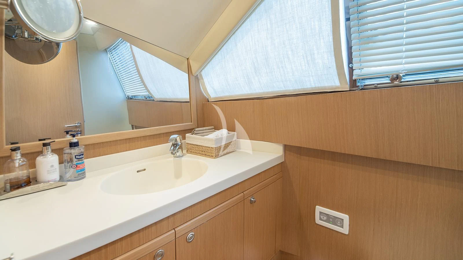 a bathroom with a mirror and a sink aboard MELI Yacht for Charter