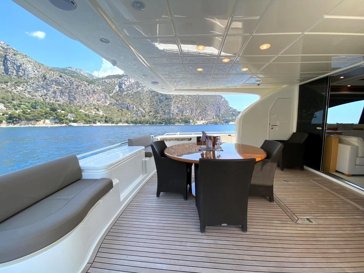 a table and chairs on a deck aboard MELI Yacht for Charter