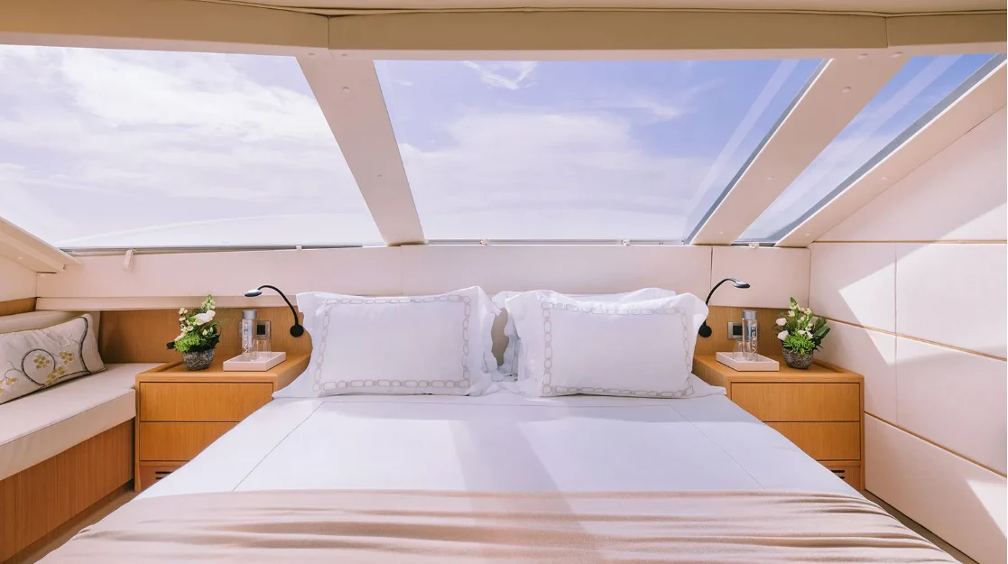 a room with a bed and a window aboard MELI Yacht for Charter
