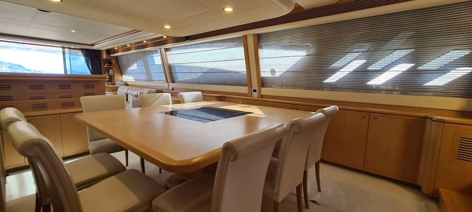 a conference room with a table and chairs aboard MELI Yacht for Charter
