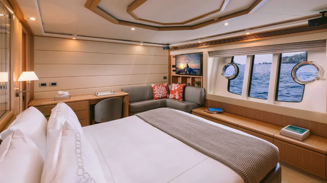 a room with a bed and a couch aboard MELI Yacht for Charter