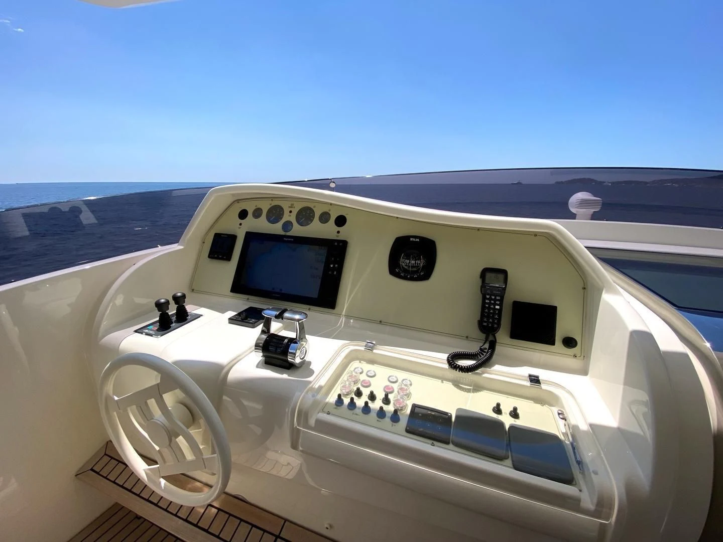 a white car with a screen aboard MELI Yacht for Charter