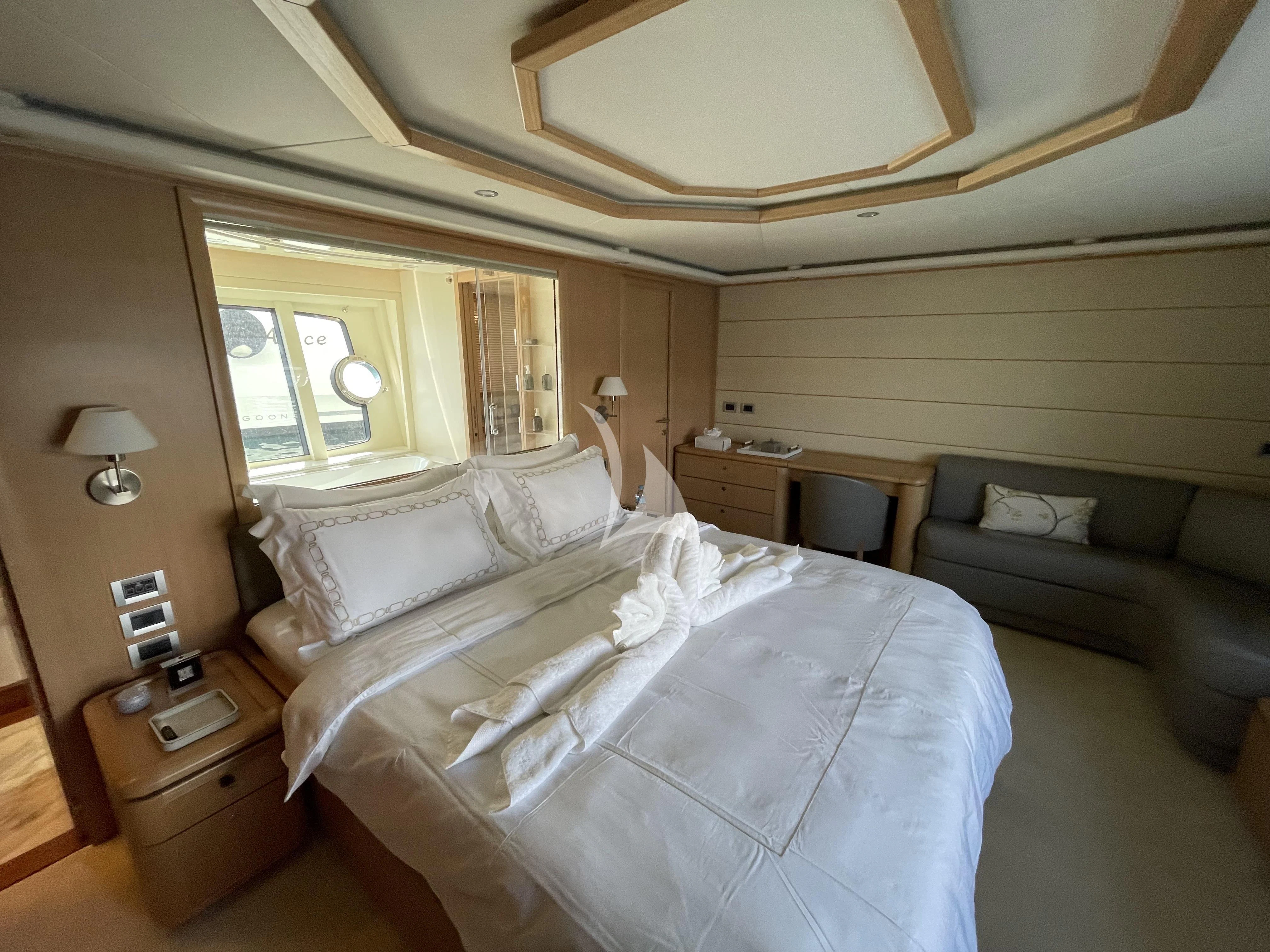 a bedroom with a bed and a couch aboard MELI Yacht for Charter