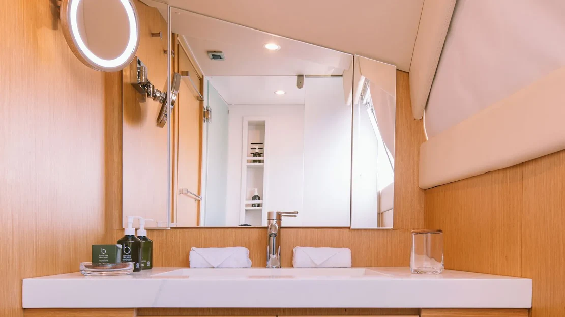 a bathroom with a large mirror aboard MELI Yacht for Charter