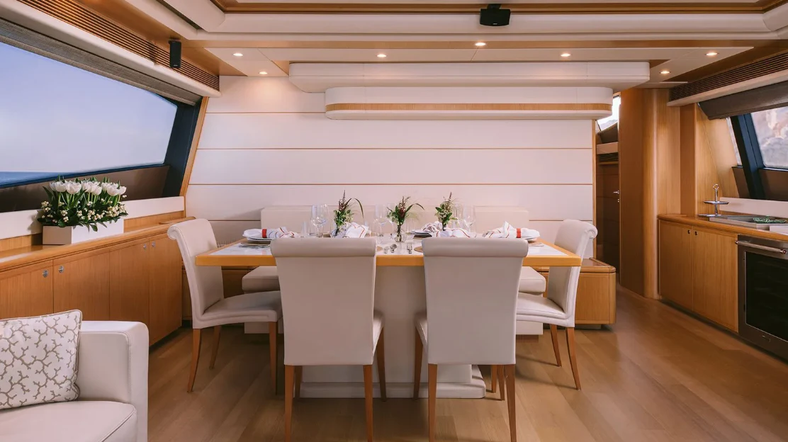 a kitchen with a table and chairs aboard MELI Yacht for Charter