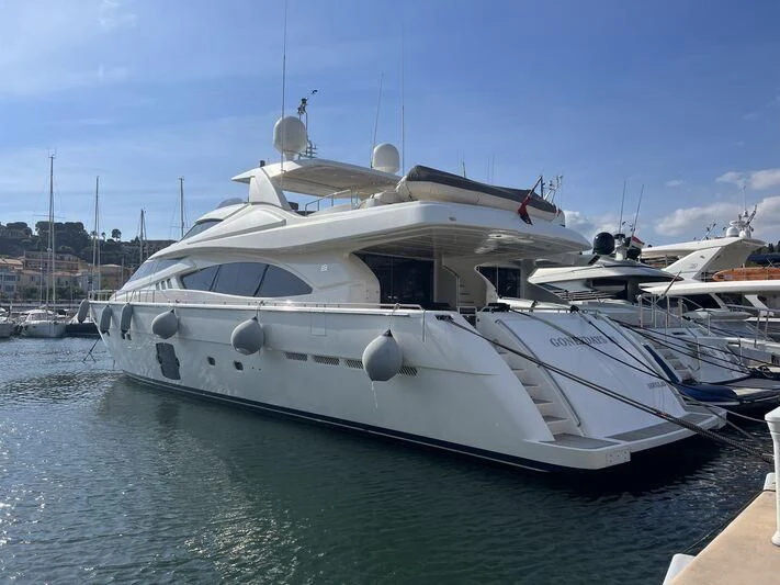 a white yacht in a harbor aboard MELI Yacht for Charter