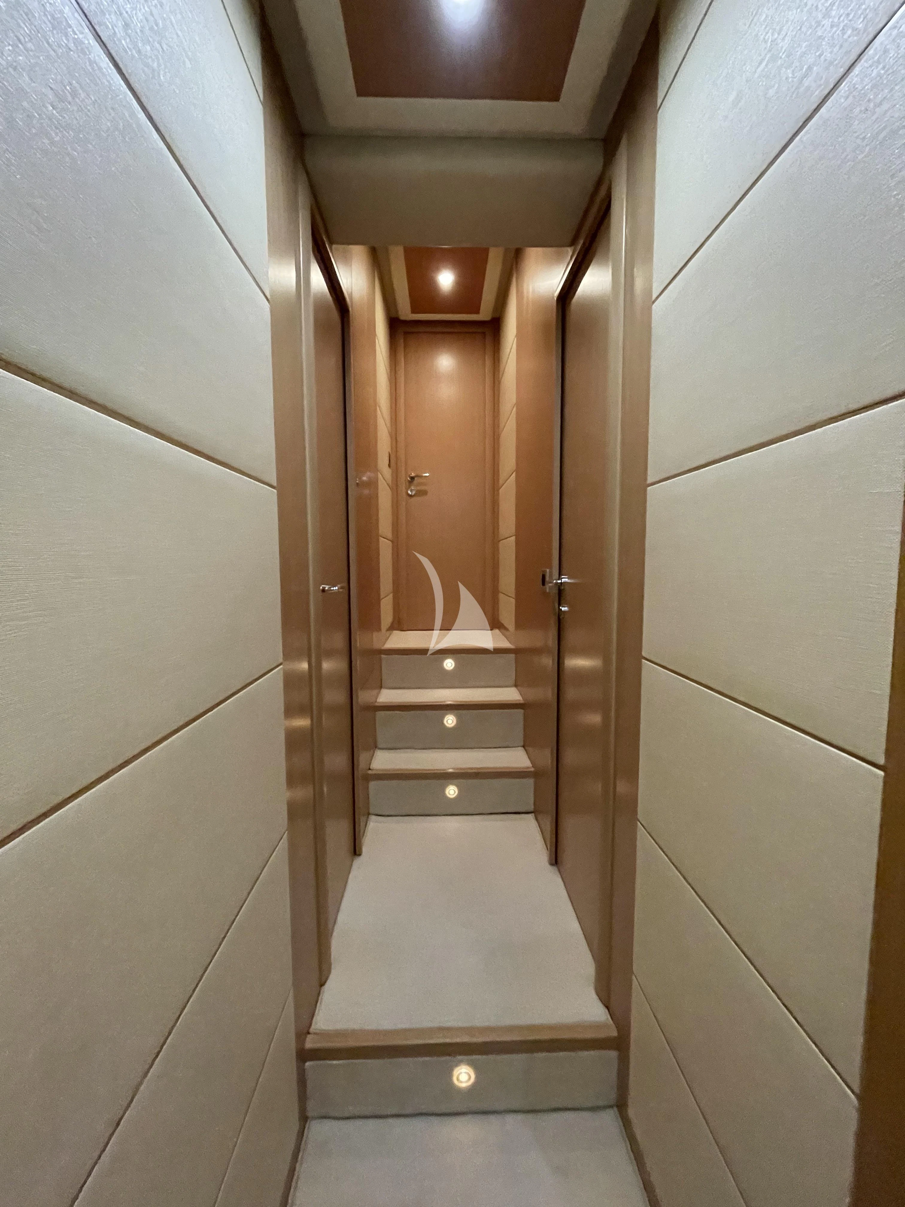 a hallway with a wood door aboard MELI Yacht for Charter