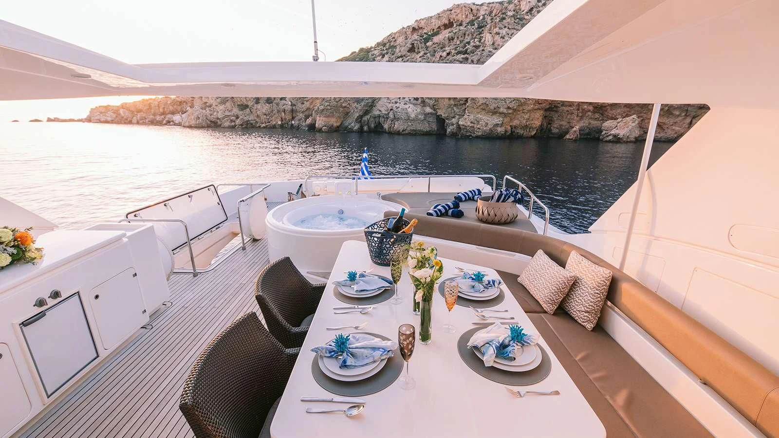 a large patio with a table and chairs on it aboard MELI Yacht for Charter