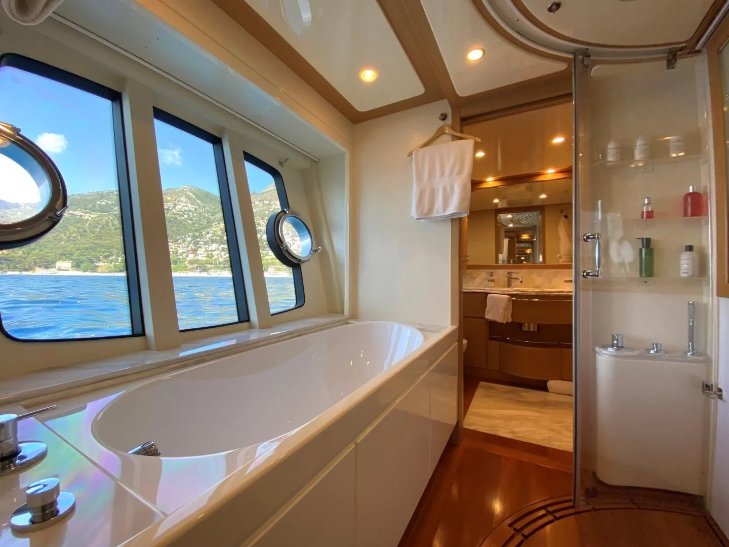 a bathroom with a tub and shower aboard MELI Yacht for Charter