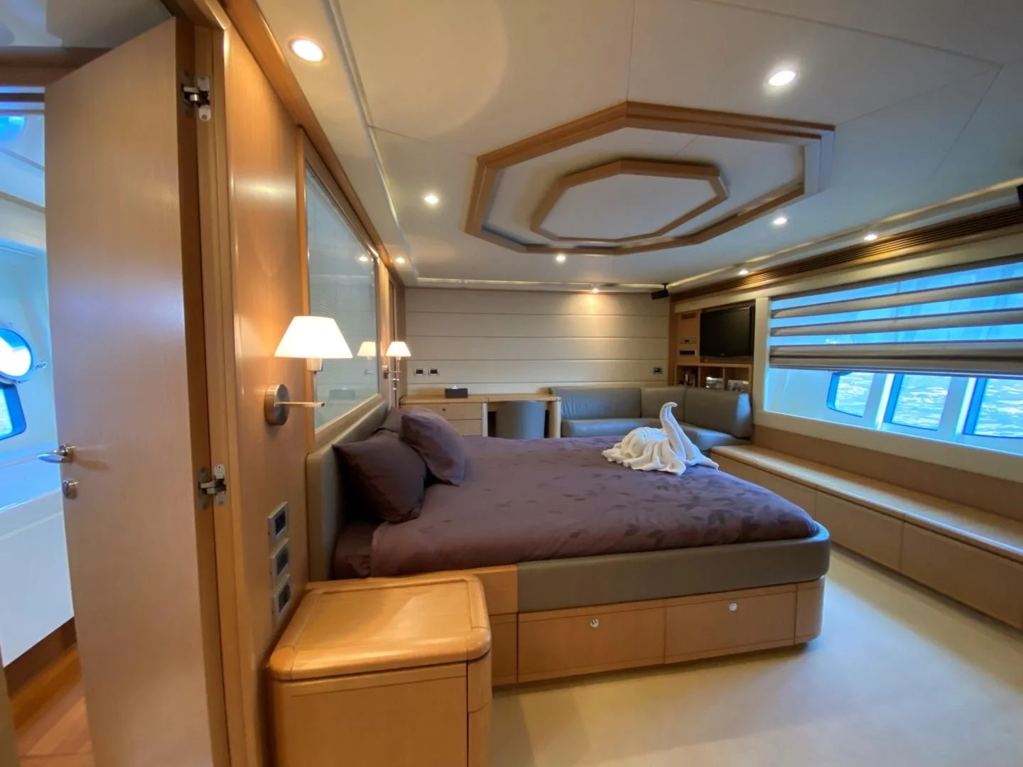 a bedroom with a bed and a desk aboard MELI Yacht for Charter