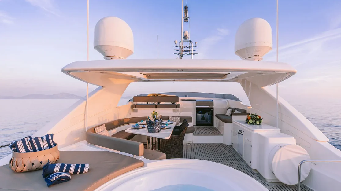 a room with a bed and a table with a lamp on it aboard MELI Yacht for Charter