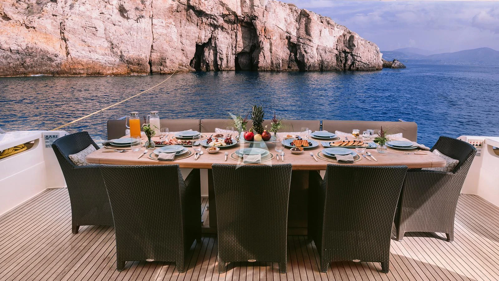 a table set for a meal on a boat aboard MELI Yacht for Charter