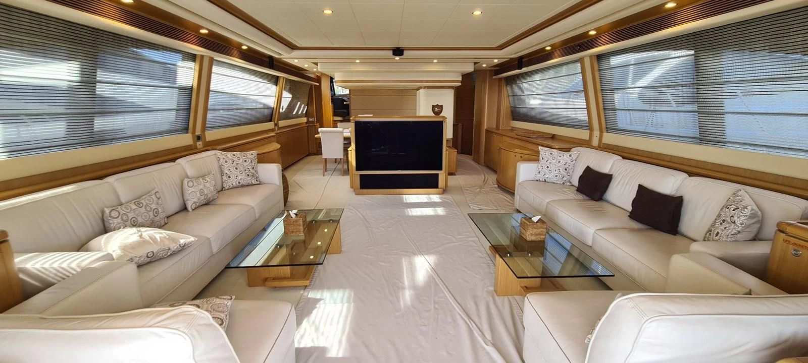 a living room with a large screen aboard MELI Yacht for Charter