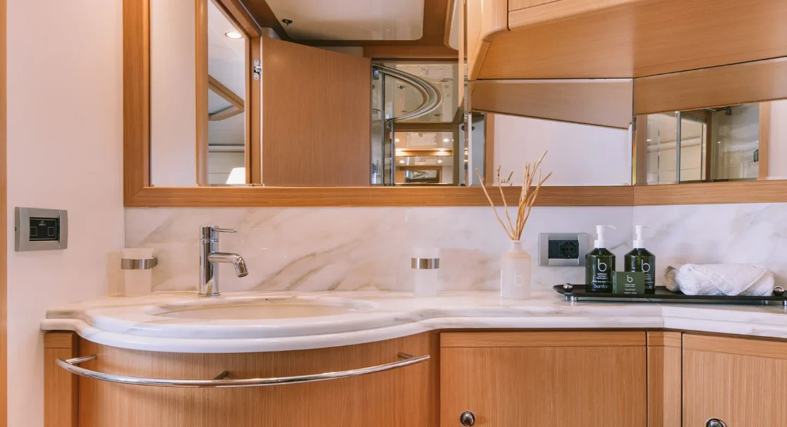a bathroom with a sink and cabinets aboard MELI Yacht for Charter