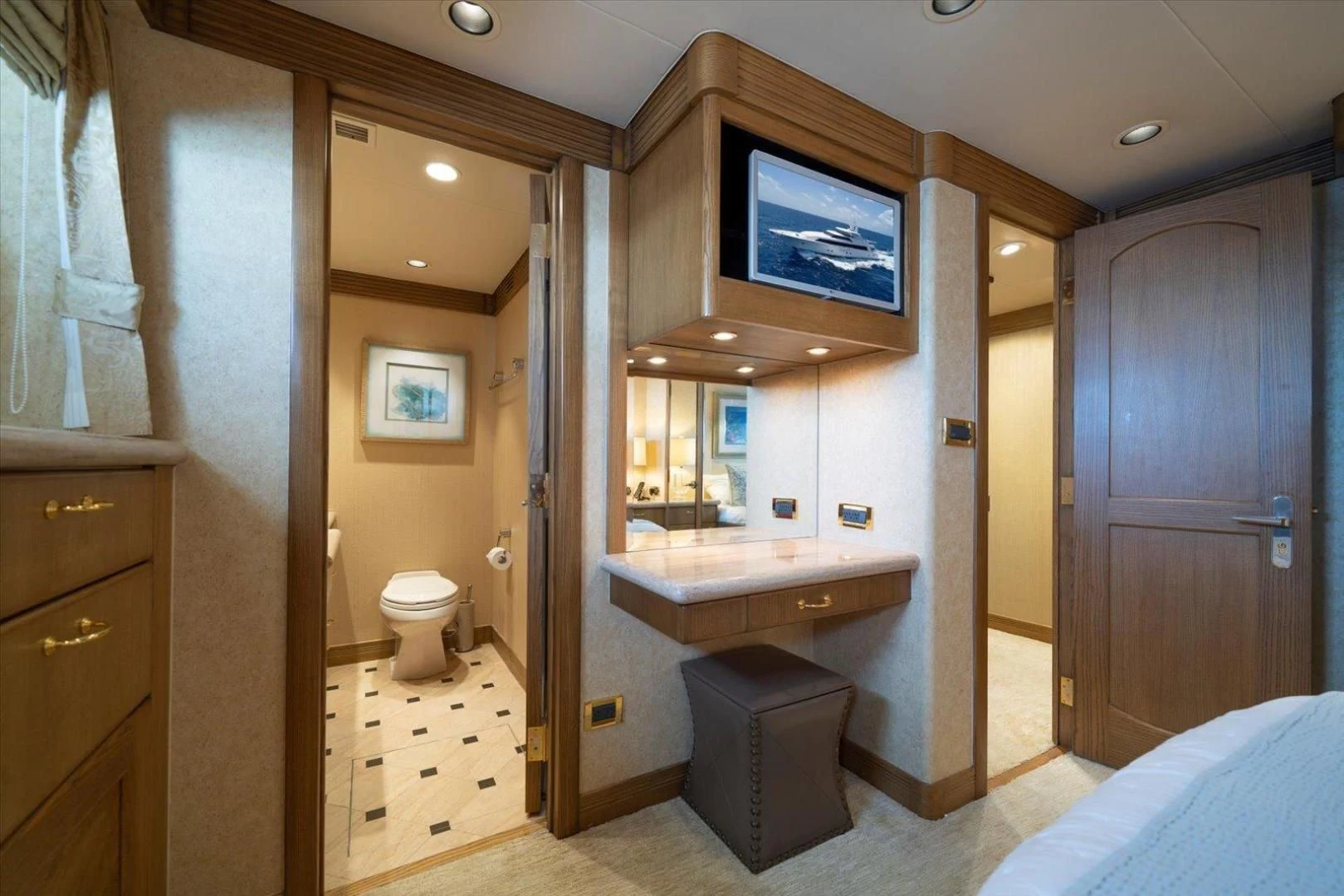 a bathroom with a sink and a tv on the wall aboard NORTH COAST 120 Yacht for Sale