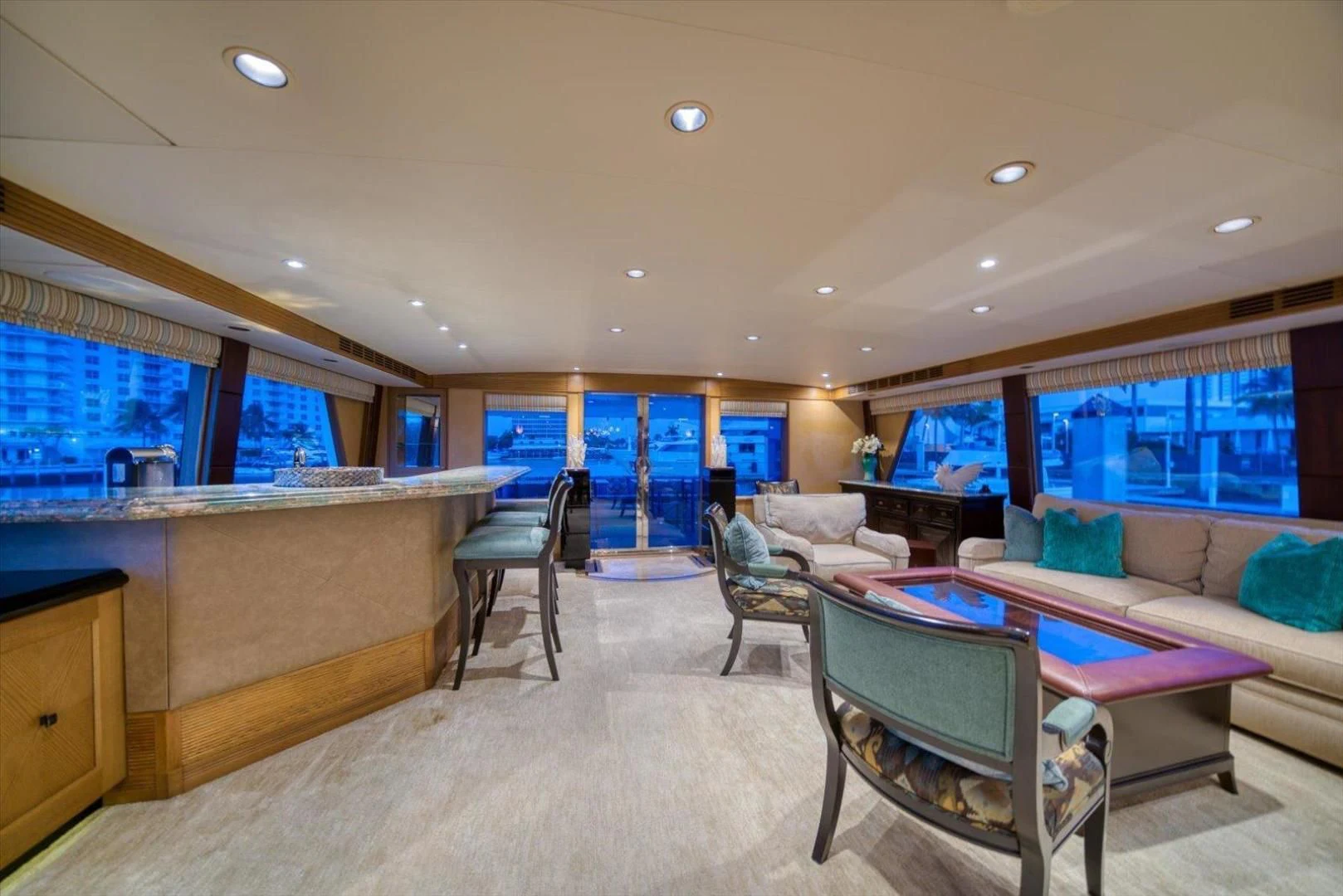 a large room with a couch and a table aboard NORTH COAST 120 Yacht for Sale