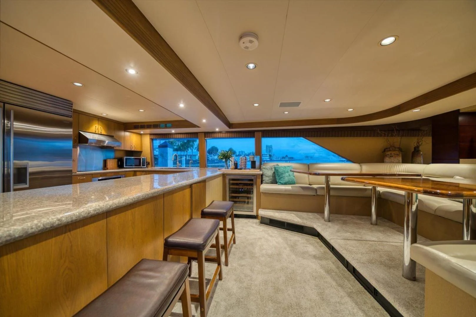 a room with a counter and chairs aboard NORTH COAST 120 Yacht for Sale