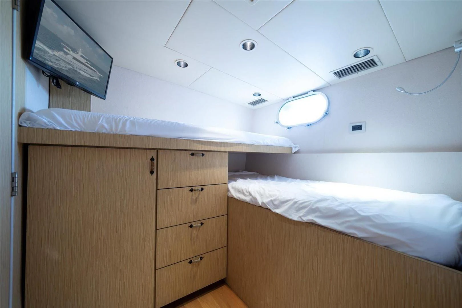 a room with a bed and a television aboard NORTH COAST 120 Yacht for Sale