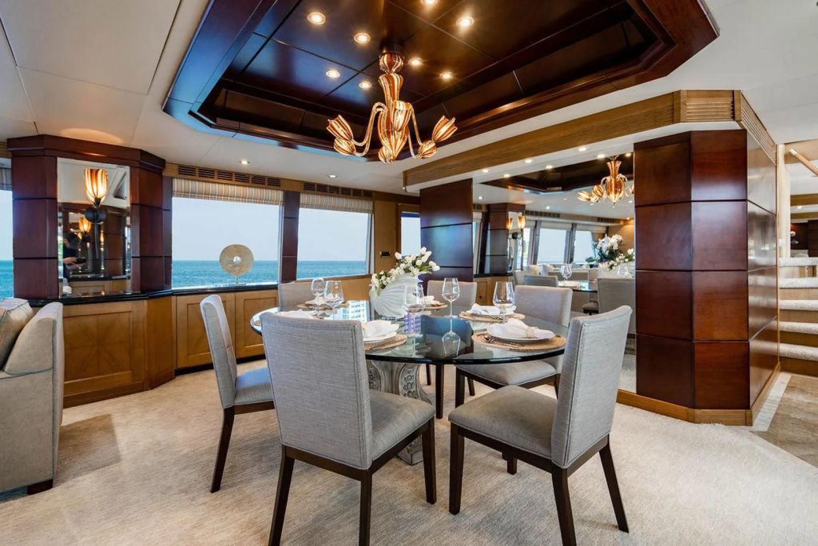 a large dining room with a chandelier aboard NORTH COAST 120 Yacht for Sale