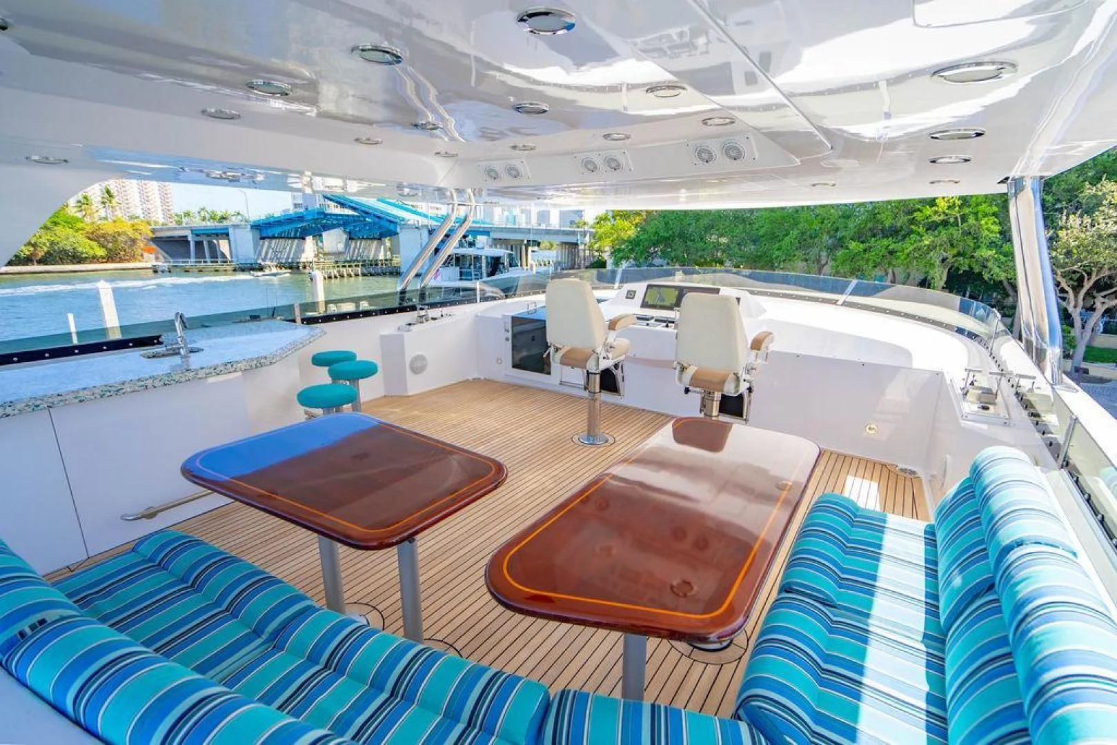 a large lounge area with a pool and a deck with chairs aboard NORTH COAST 120 Yacht for Sale
