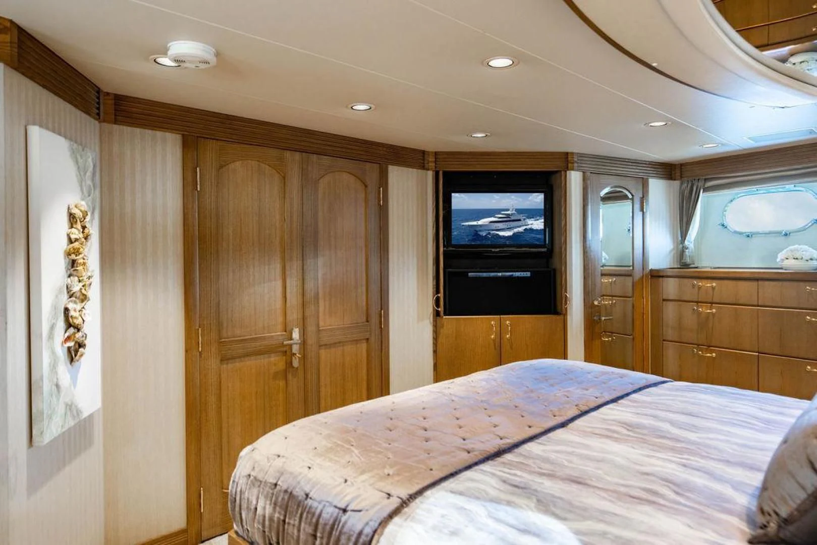 a bedroom with a bed and a television aboard NORTH COAST 120 Yacht for Sale