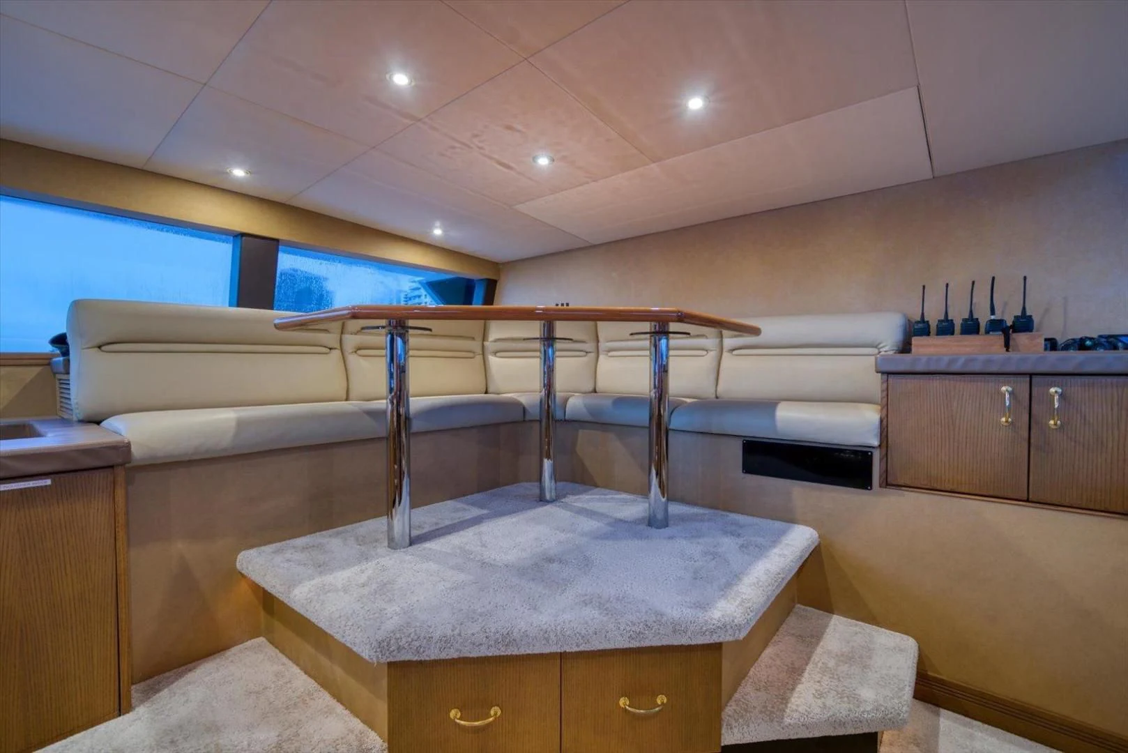 a room with a bar and a table aboard NORTH COAST 120 Yacht for Sale