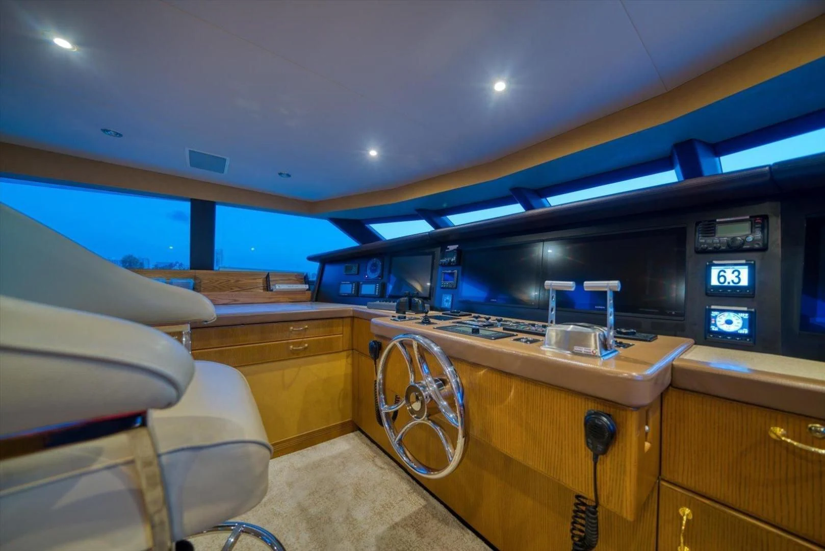 a room with a counter and chairs aboard NORTH COAST 120 Yacht for Sale