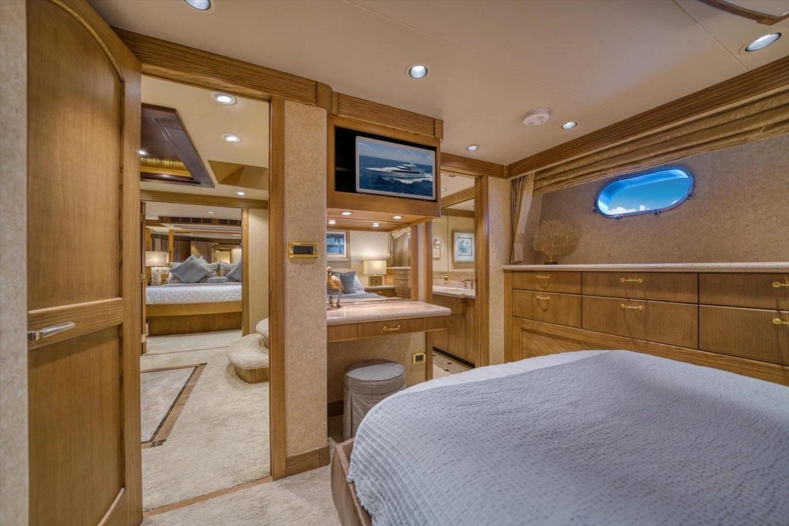 a bedroom with a bed and desk aboard NORTH COAST 120 Yacht for Sale