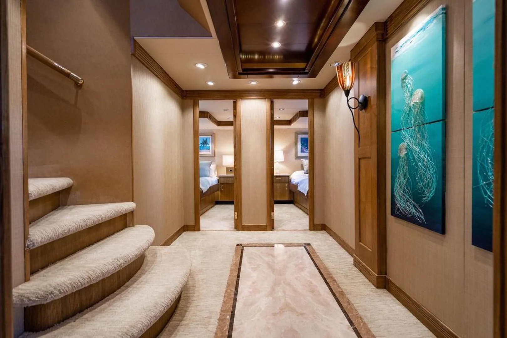 a room with a staircase and a rug aboard NORTH COAST 120 Yacht for Sale