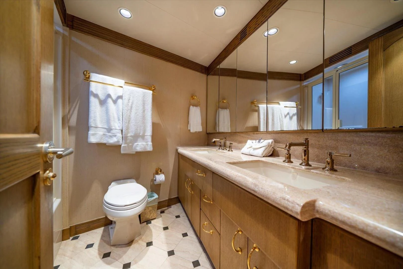a bathroom with a sink toilet and a mirror aboard NORTH COAST 120 Yacht for Sale