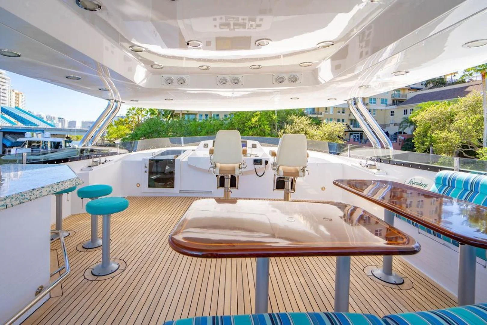 a lounge area with a table and chairs on it aboard NORTH COAST 120 Yacht for Sale