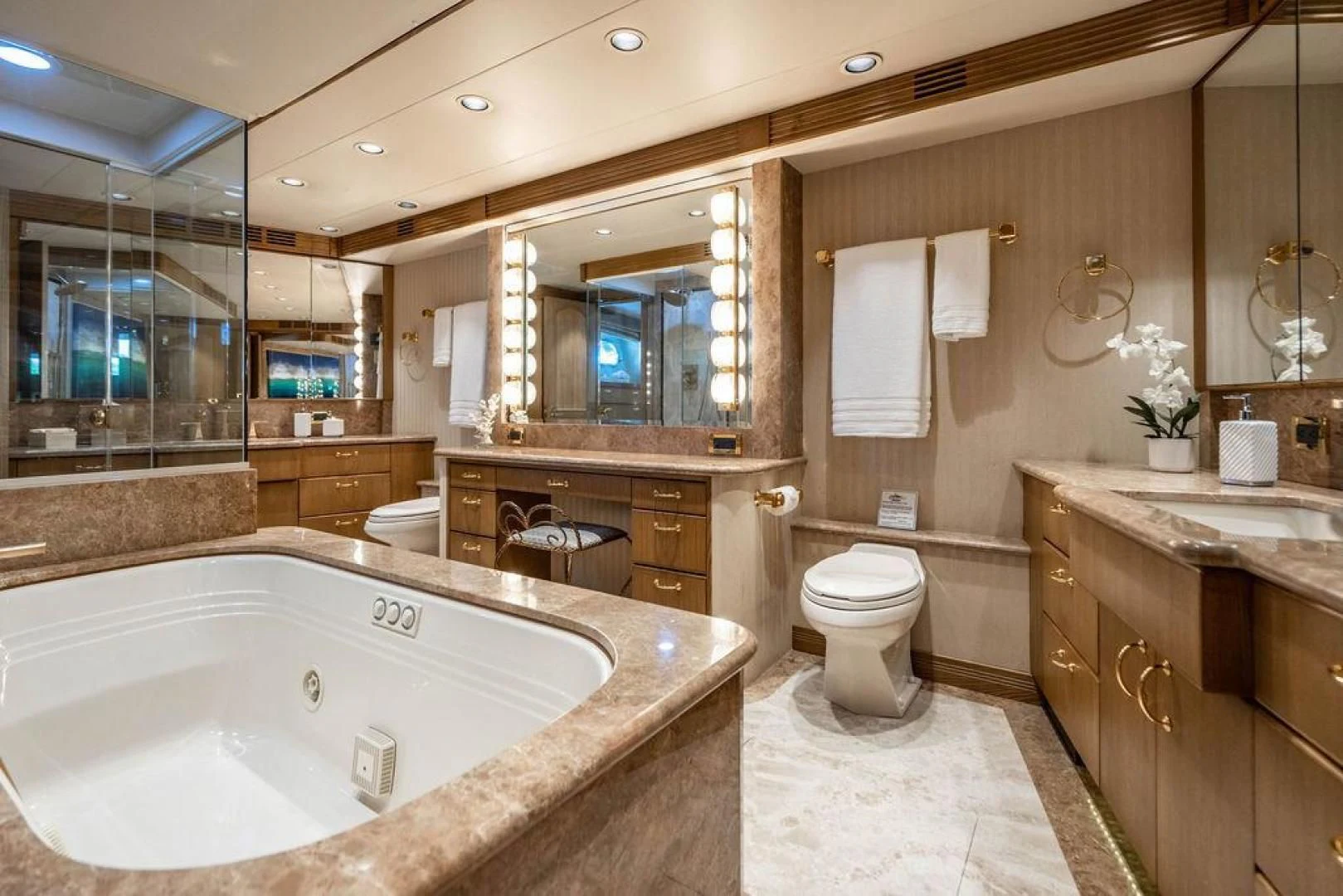 a bathroom with a tub toilet and sink aboard NORTH COAST 120 Yacht for Sale