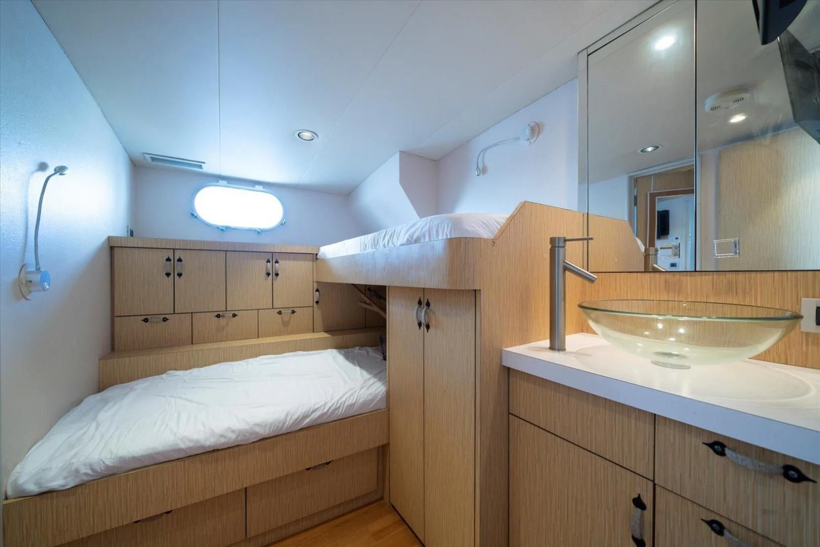 a bathroom with a sink and a bed aboard NORTH COAST 120 Yacht for Sale
