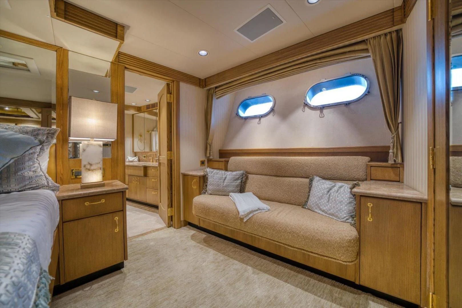 a living room with a couch and a window aboard NORTH COAST 120 Yacht for Sale