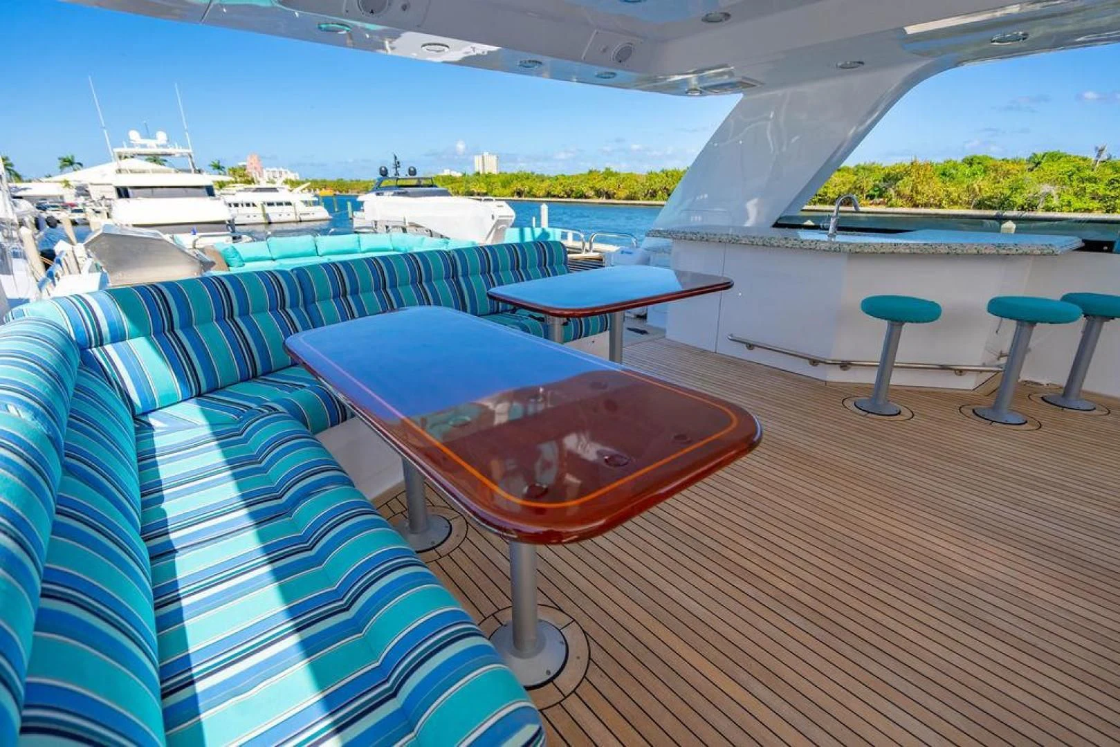 a deck with a table and chairs on it aboard NORTH COAST 120 Yacht for Sale