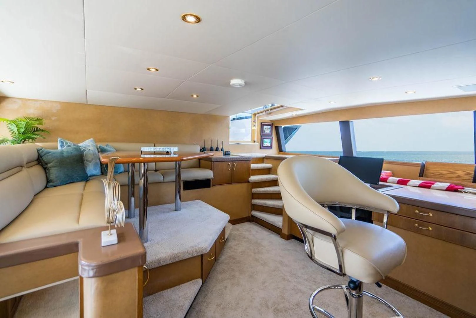 a living room with a couch and a table aboard NORTH COAST 120 Yacht for Sale